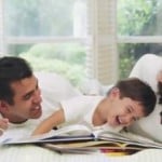 Parents Reading to Laughing Boy